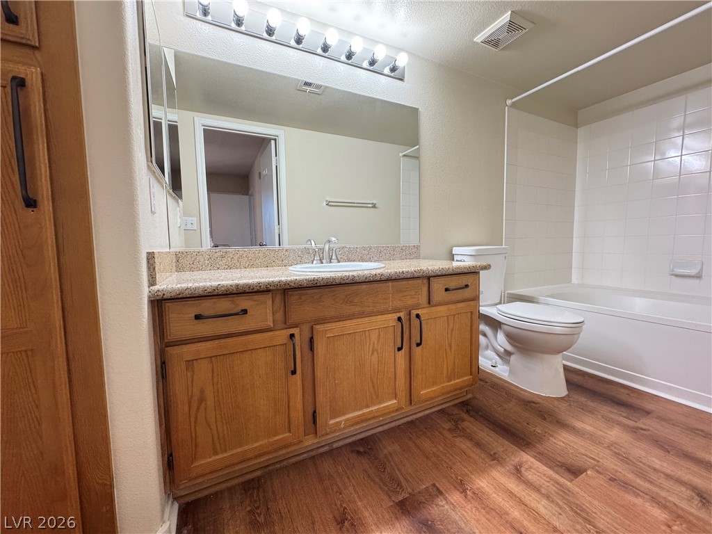 7255 West Sunset Road, Unit 2111 Las Vegas, NV 89113 - Photo 15 of 33 Well-appointed bathroom showcasing a functional vanity with ample storage and durable wood flooring.