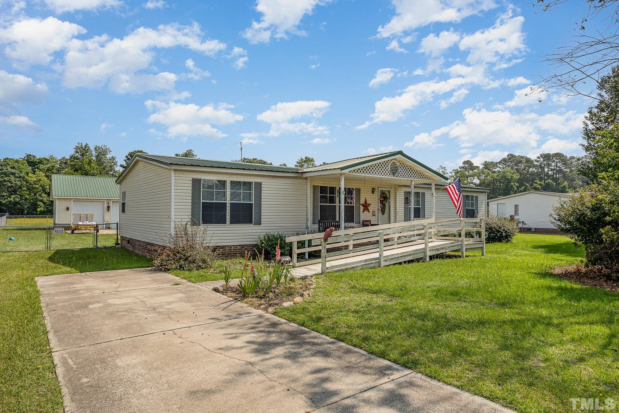 6301 Sandy Creek Road Stedman, NC 28391 - Photo 1 of 27 a front view of house with yard patio and green space