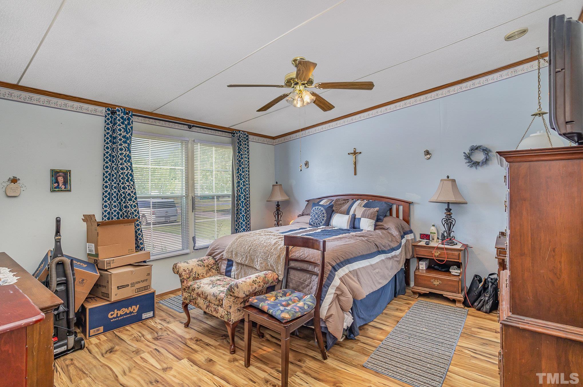 6301 Sandy Creek Road Stedman, NC 28391 - Photo 19 of 27 a bedroom with a bed and wooden floor