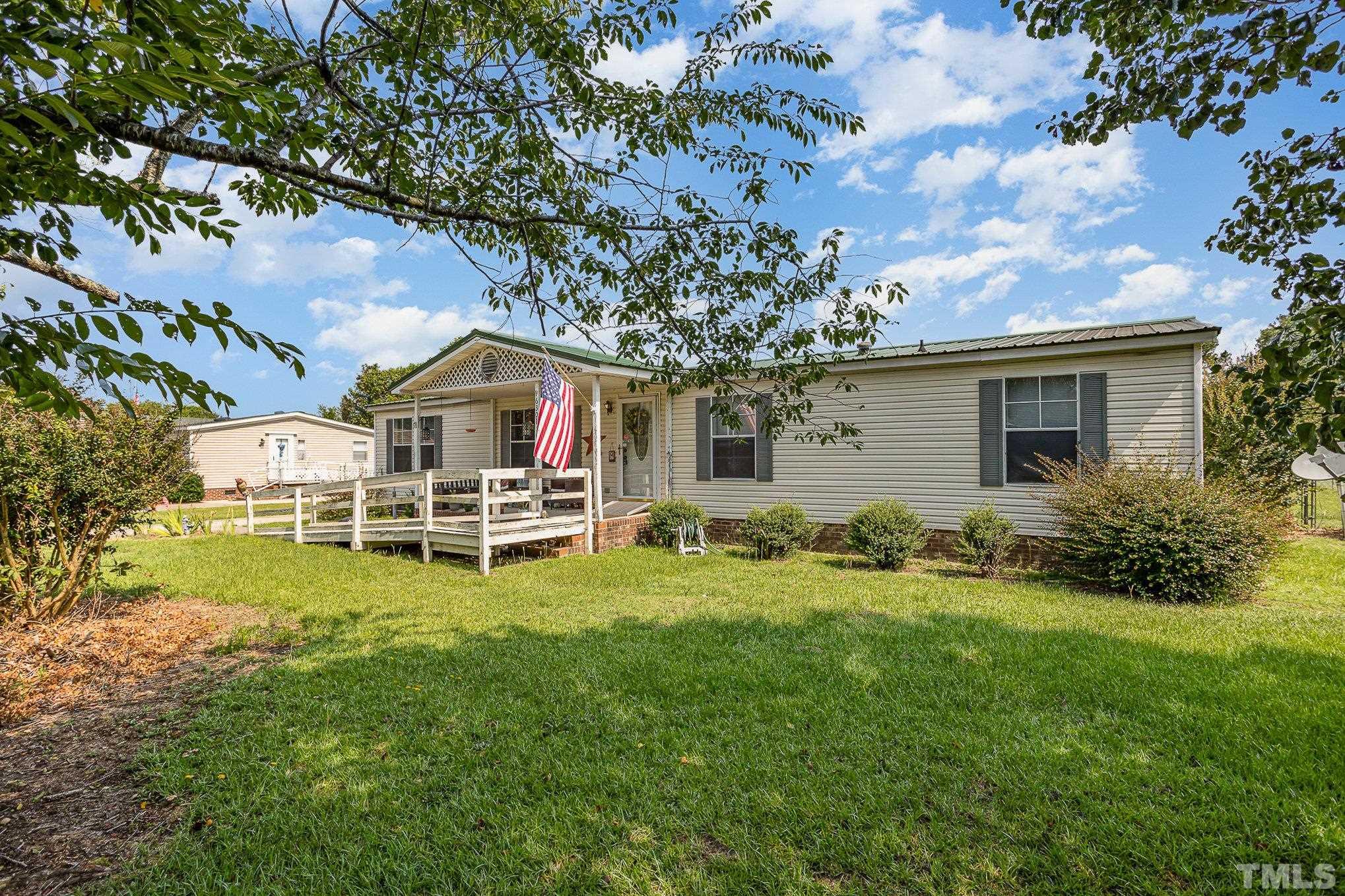 6301 Sandy Creek Road Stedman, NC 28391 - Photo 2 of 27 a front view of house with yard and seating area