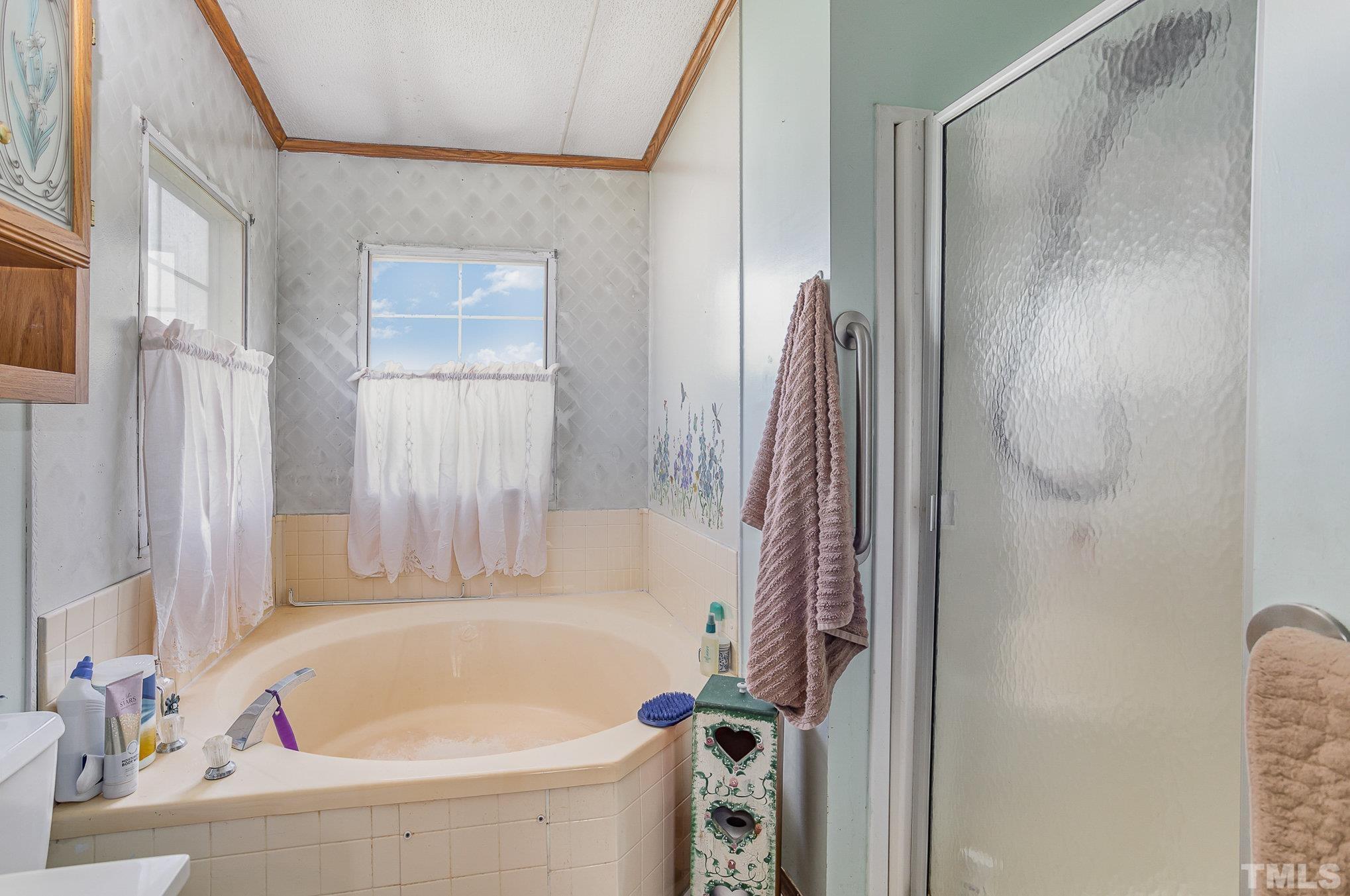 6301 Sandy Creek Road Stedman, NC 28391 - Photo 22 of 27 a bathroom with a tub and a shower