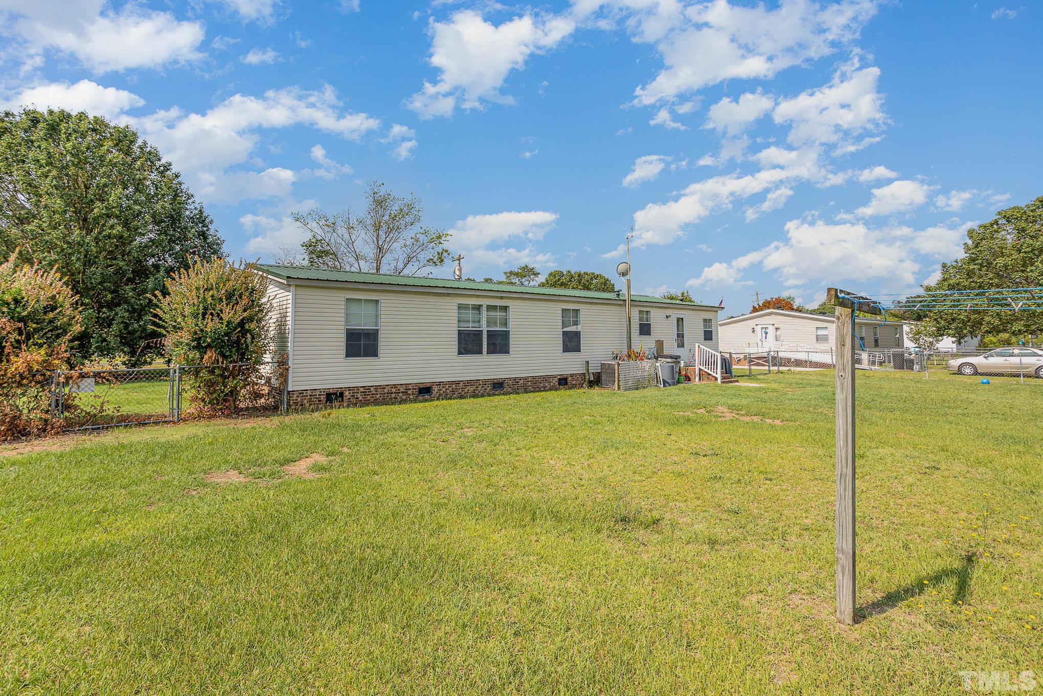 6301 Sandy Creek Road Stedman, NC 28391 - Photo 24 of 27 a view of a house with backyard and garden