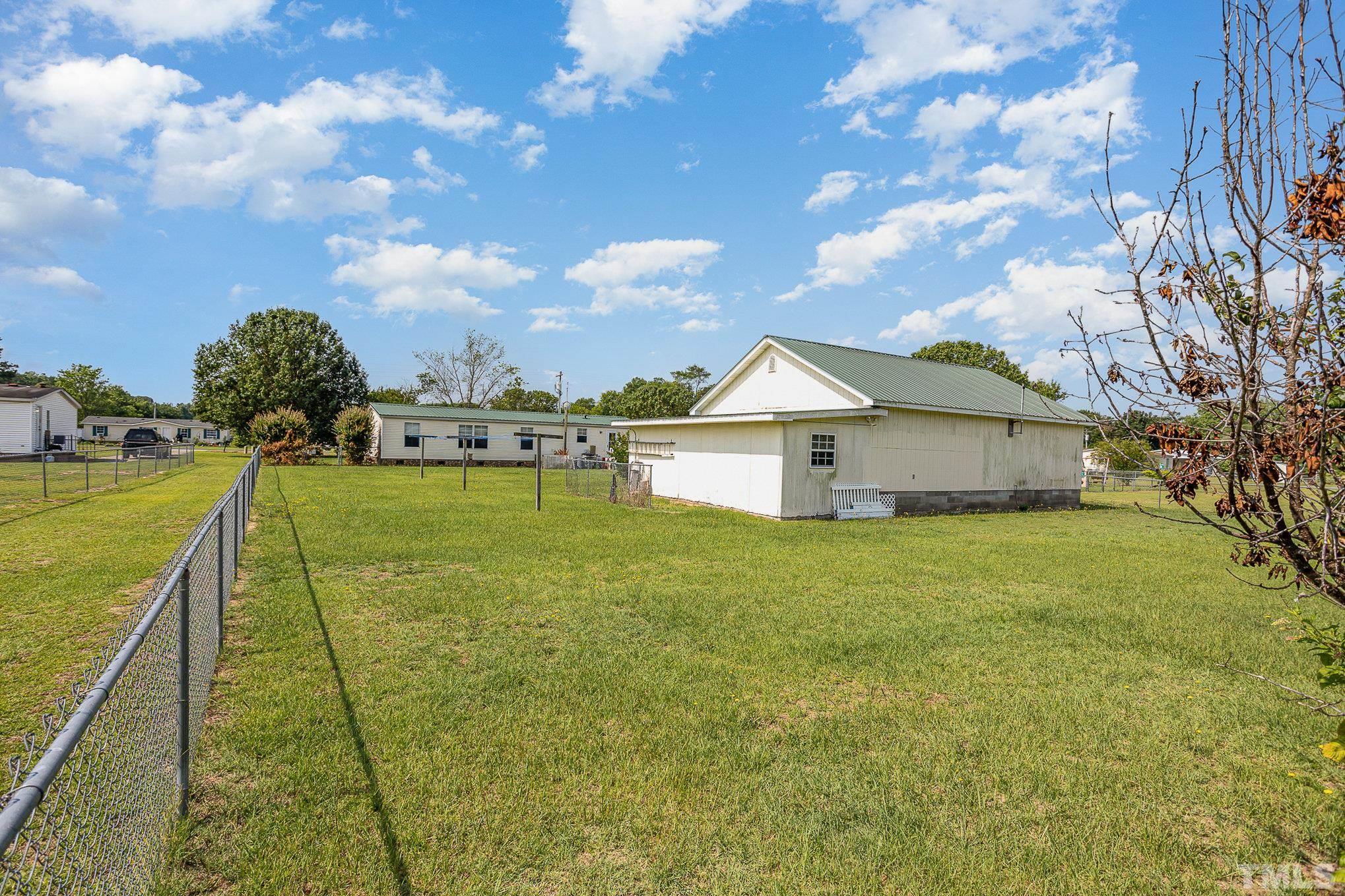 6301 Sandy Creek Road Stedman, NC 28391 - Photo 26 of 27 a view of a house with a yard