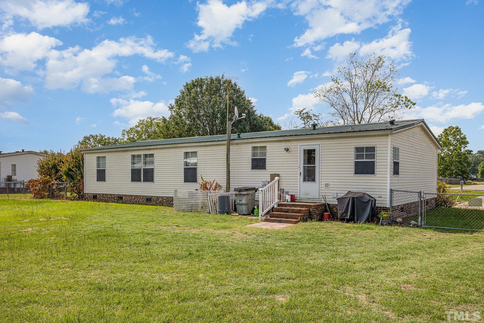 6301 Sandy Creek Road Stedman, NC 28391 - Photo 4 of 27 a view of a house with a back yard