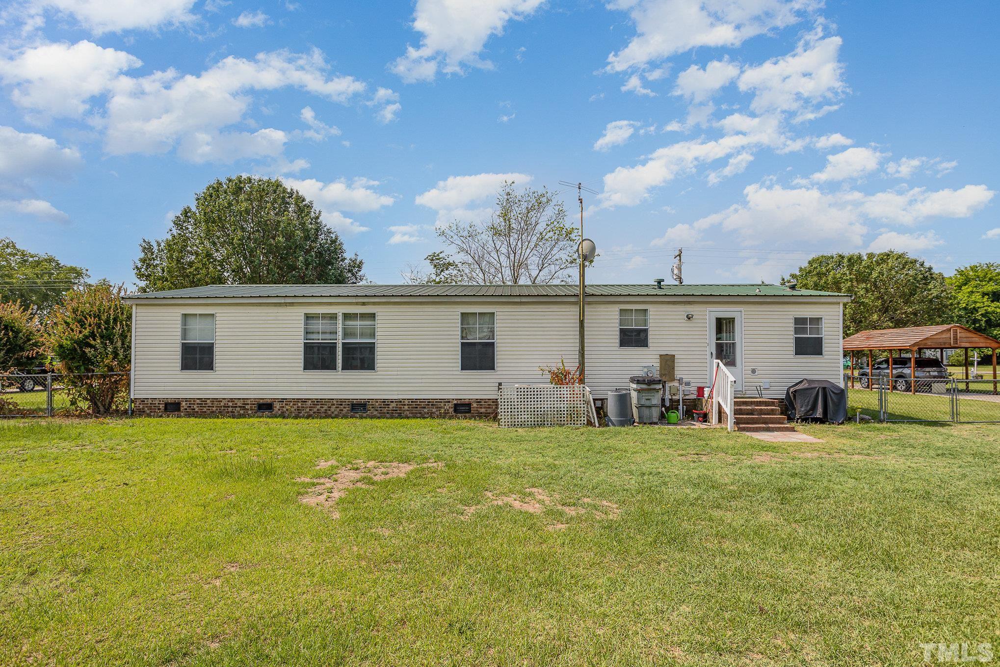 6301 Sandy Creek Road Stedman, NC 28391 - Photo 5 of 27 a view of a house with a backyard