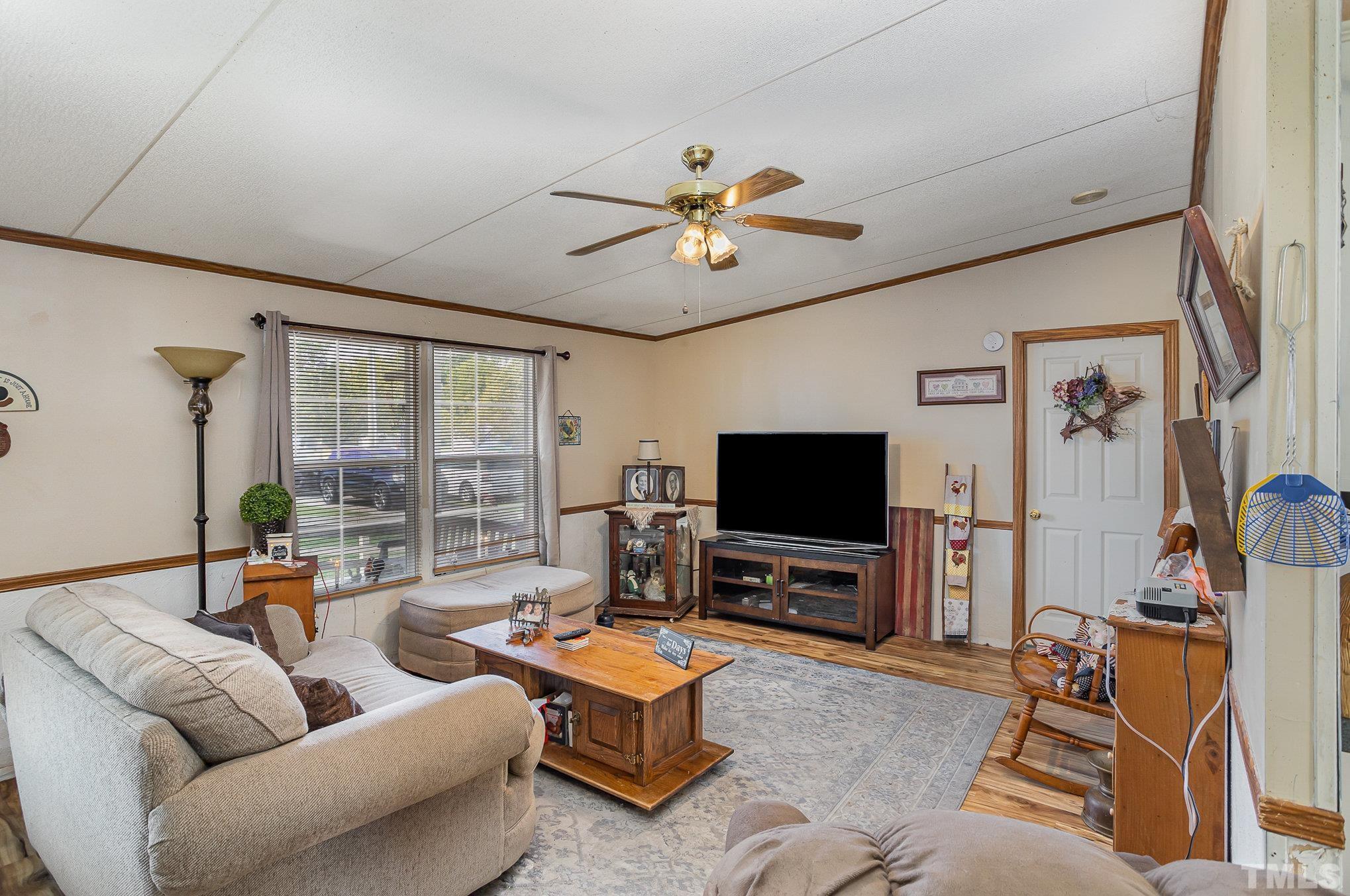 6301 Sandy Creek Road Stedman, NC 28391 - Photo 8 of 27 a living room with furniture and a flat screen tv