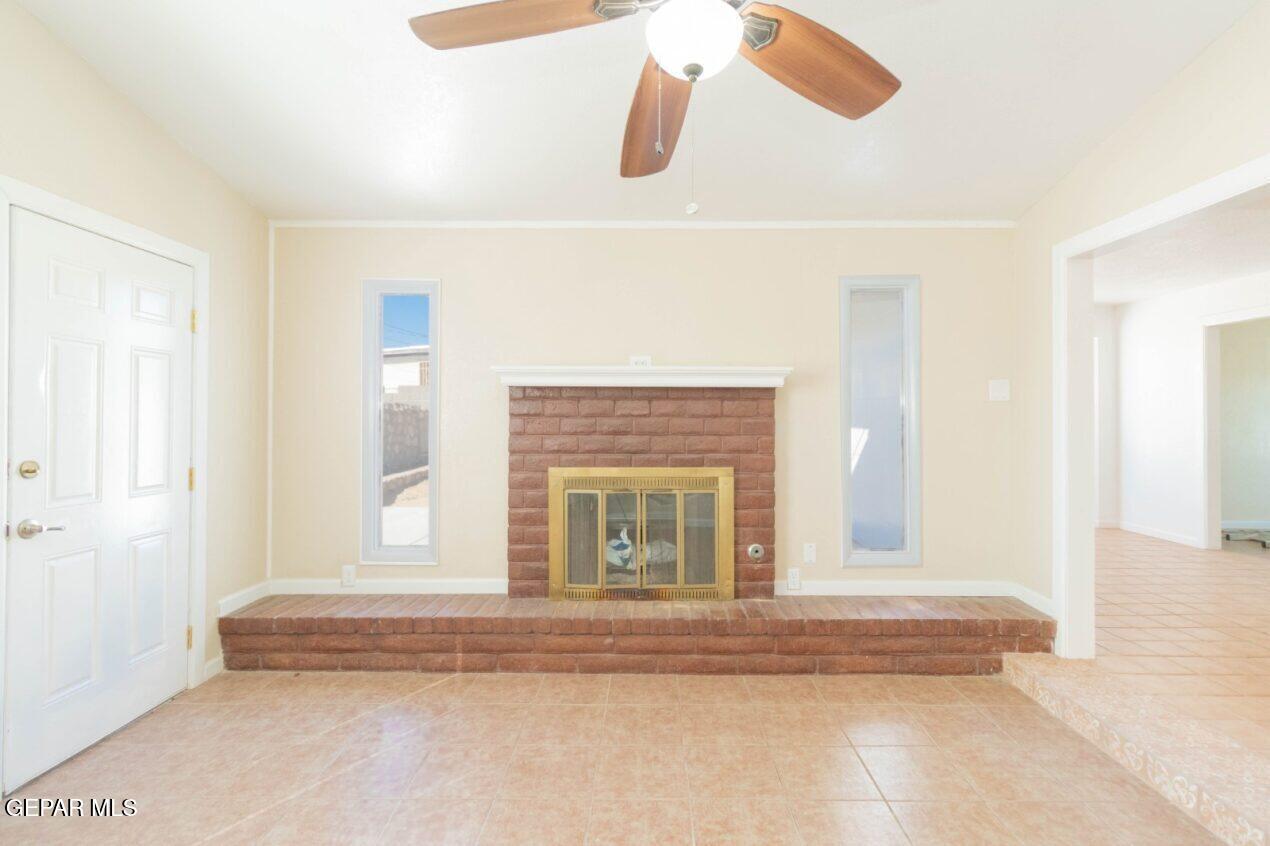 6240 Cibolo Court El Paso, TX 79905 - Photo 15 of 50 a living room with a fireplace furniture and a large window