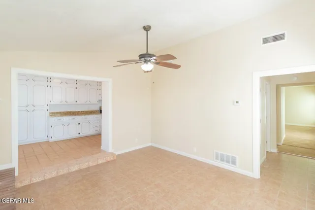 a view of a room with a ceiling fan