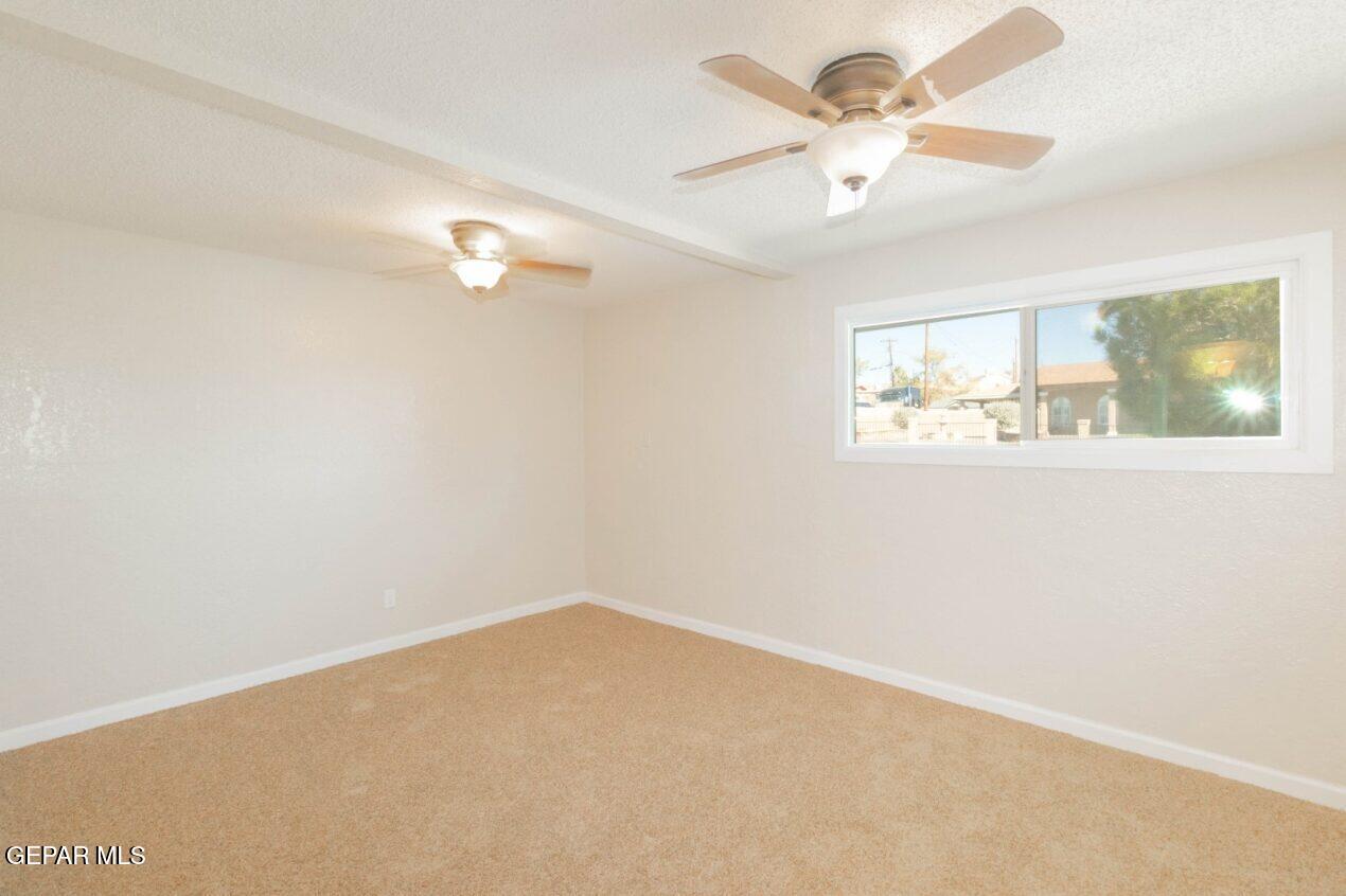6240 Cibolo Court El Paso, TX 79905 - Photo 18 of 50 an empty room with a window and a ceiling fan