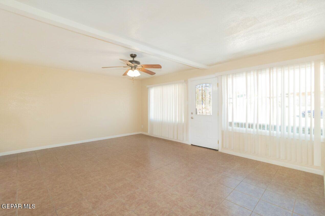 6240 Cibolo Court El Paso, TX 79905 - Photo 2 of 50 an empty room with windows and chandelier fan