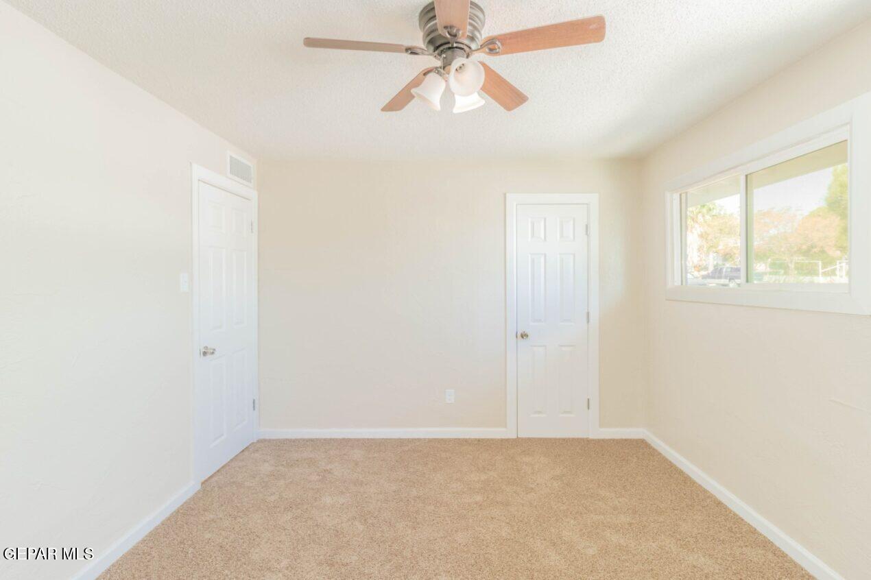 6240 Cibolo Court El Paso, TX 79905 - Photo 21 of 50 an empty room with windows and fan