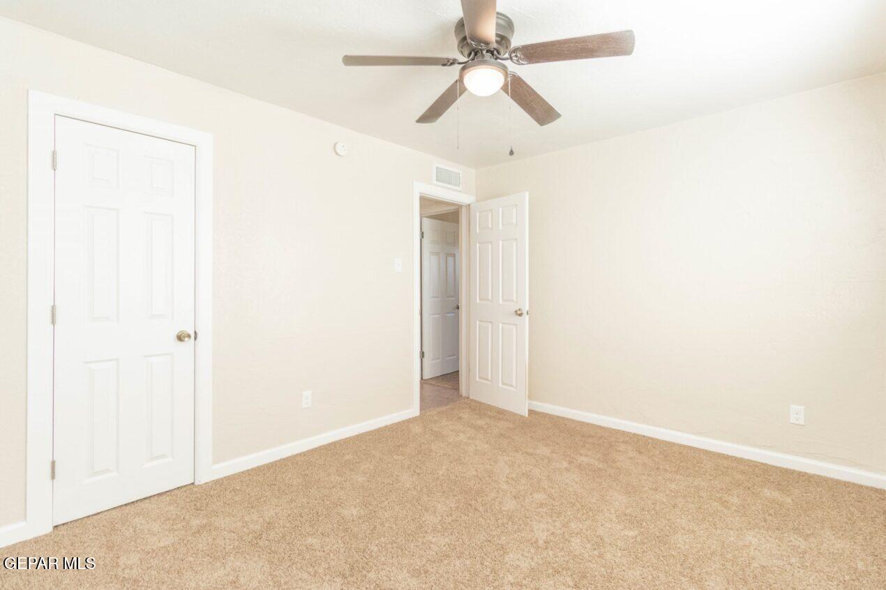 6240 Cibolo Court El Paso, TX 79905 - Photo 26 of 50 an empty room with a ceiling fan and a window