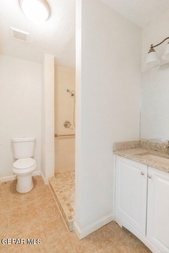 6240 Cibolo Court El Paso, TX 79905 - Photo 32 of 50 a bathroom with a granite countertop sink and a toilet