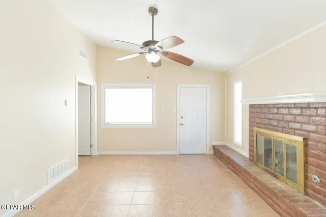 a view of livingroom with chandelier fan and a fireplace