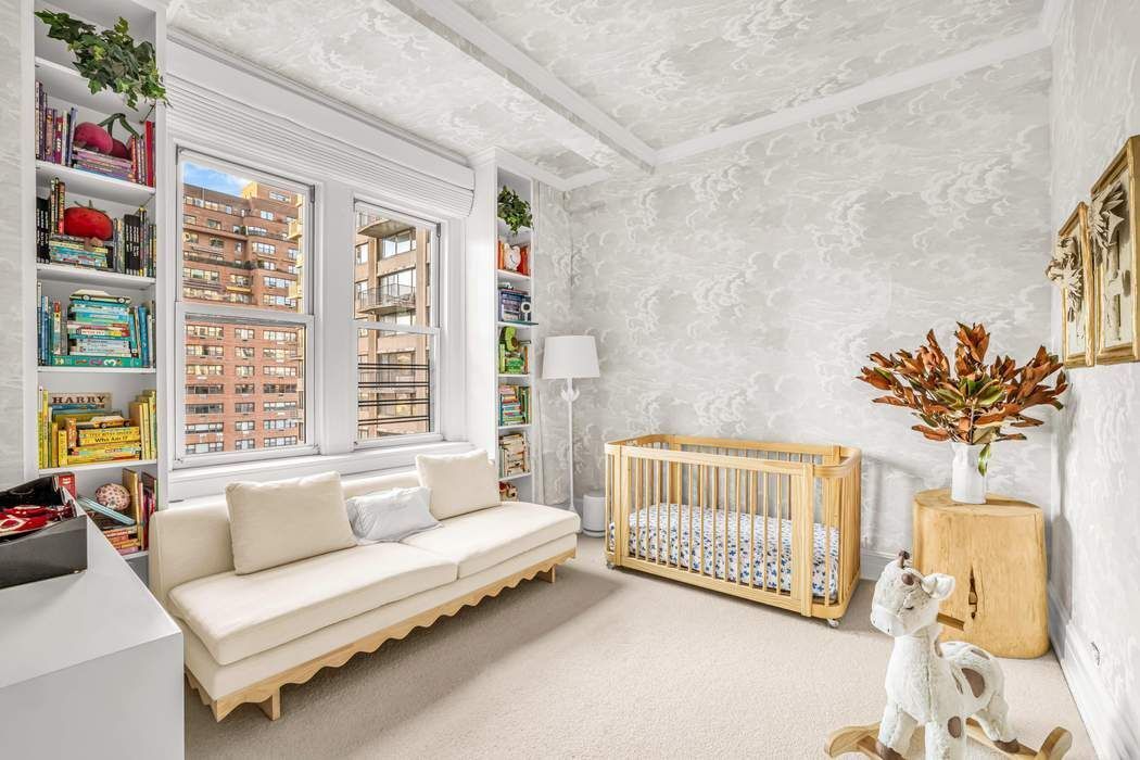 215 East 72nd Street, Unit 10W Manhattan, NY 10021 - Photo 10 of 14 a bedroom with furniture and a large window