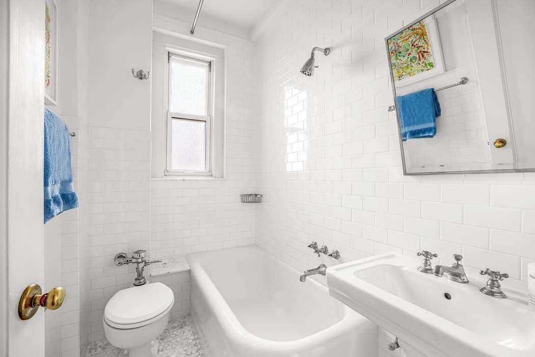 215 East 72nd Street, Unit 10W Manhattan, NY 10021 - Photo 11 of 14 a bathroom with a sink and a mirror