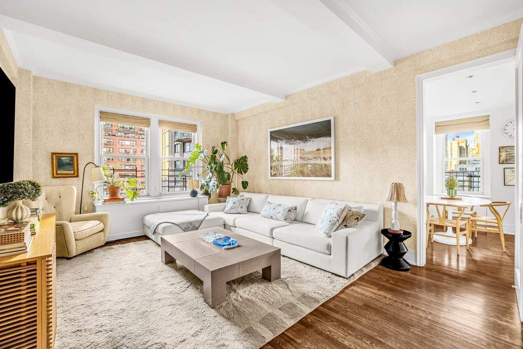 215 East 72nd Street, Unit 10W Manhattan, NY 10021 - Photo 3 of 14 a living room with furniture and a large window