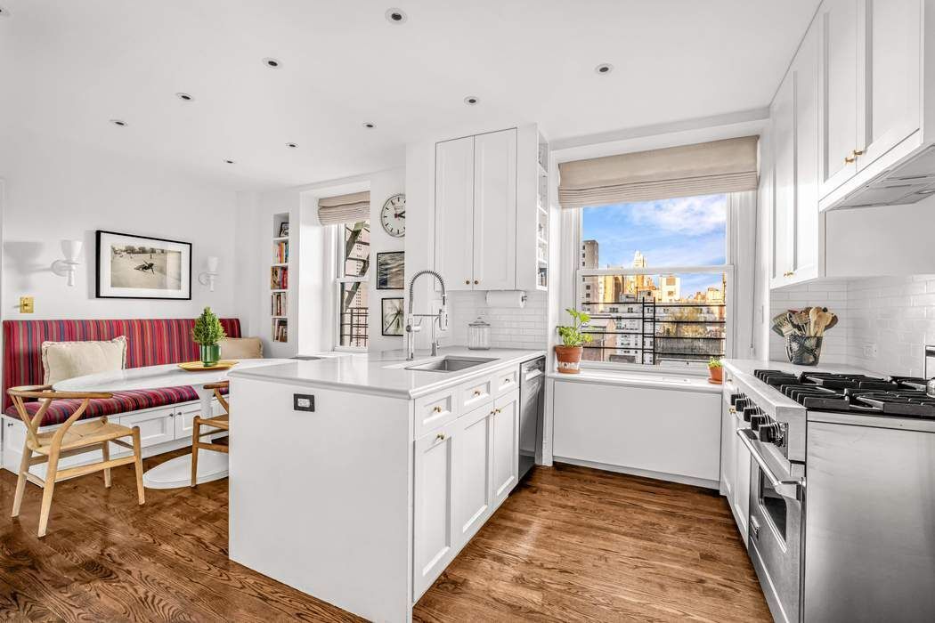 215 East 72nd Street, Unit 10W Manhattan, NY 10021 - Photo 4 of 14 a kitchen with a sink stove and cabinets