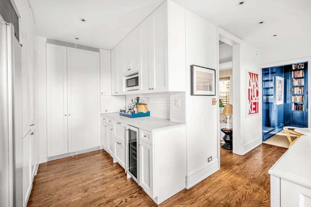 215 East 72nd Street, Unit 10W Manhattan, NY 10021 - Photo 6 of 14 a kitchen with stainless steel appliances granite countertop a refrigerator and a stove