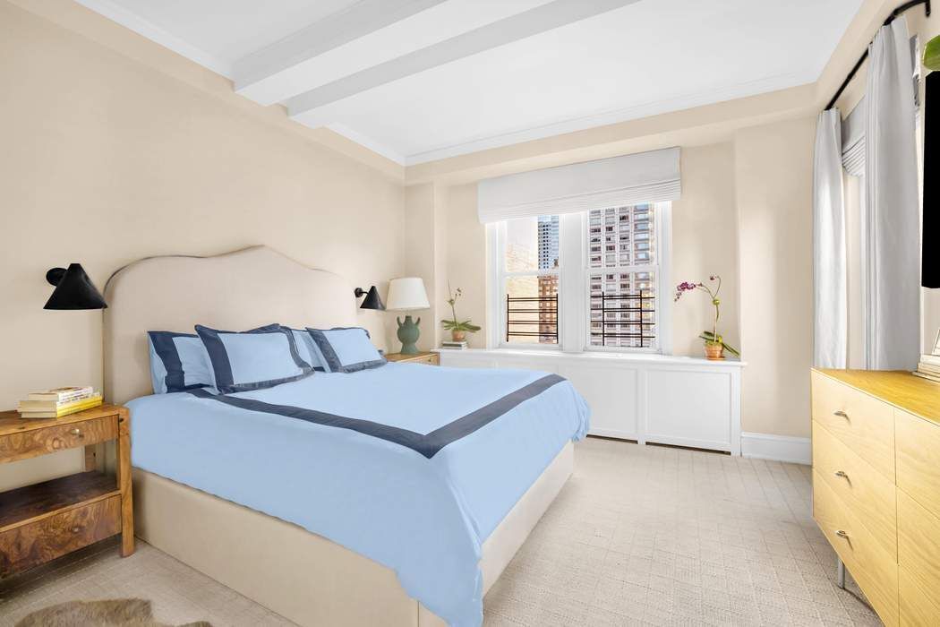 215 East 72nd Street, Unit 10W Manhattan, NY 10021 - Photo 7 of 14 a spacious bedroom with a bed and a large window