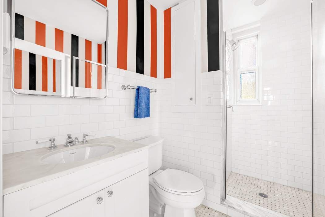 215 East 72nd Street, Unit 10W Manhattan, NY 10021 - Photo 8 of 14 a bathroom with a sink and a toilet