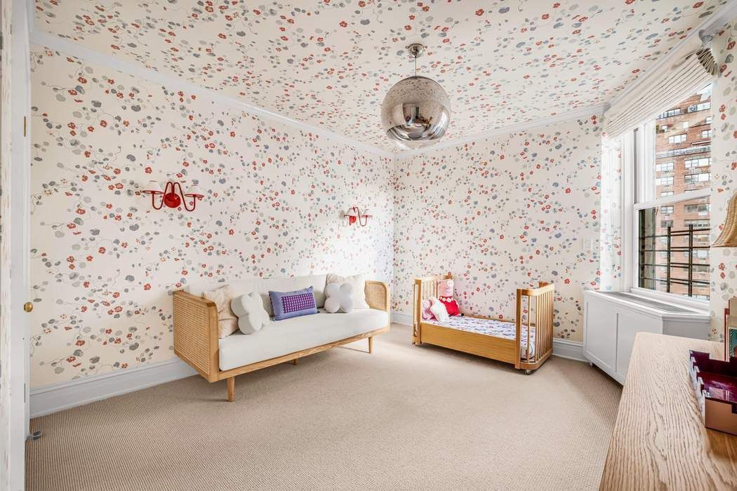 215 East 72nd Street, Unit 10W Manhattan, NY 10021 - Photo 9 of 14 a living room with furniture and a flat screen tv