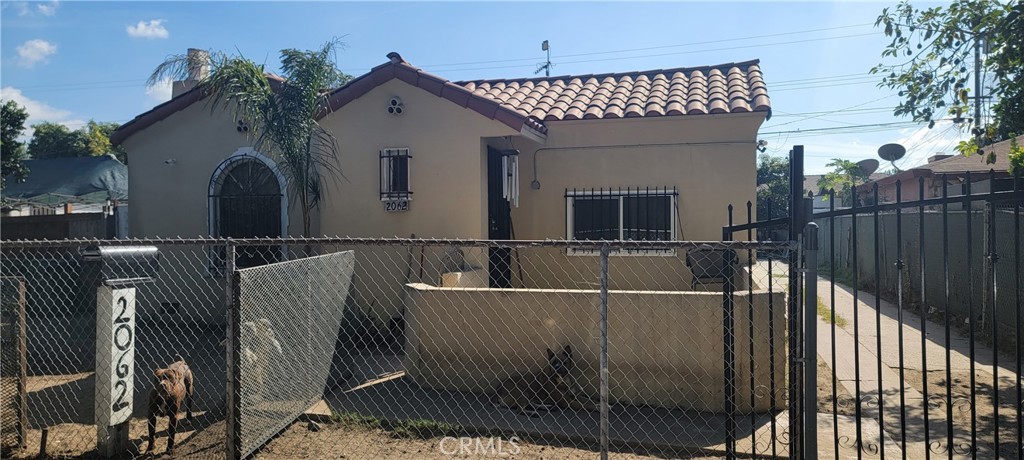 2062 East Hatchway Street Compton, CA 90222 - Photo 2 of 4 a front view of a house with iron fence