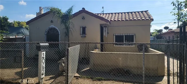 a front view of a house with wooden fence