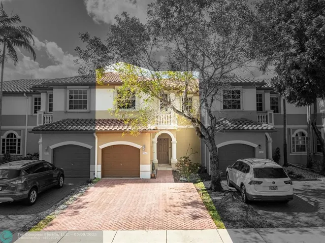 a front view of a house with parking space