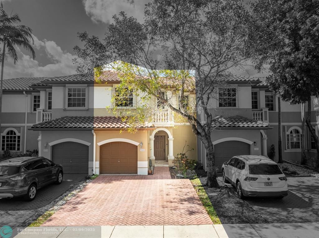a front view of a house with parking space