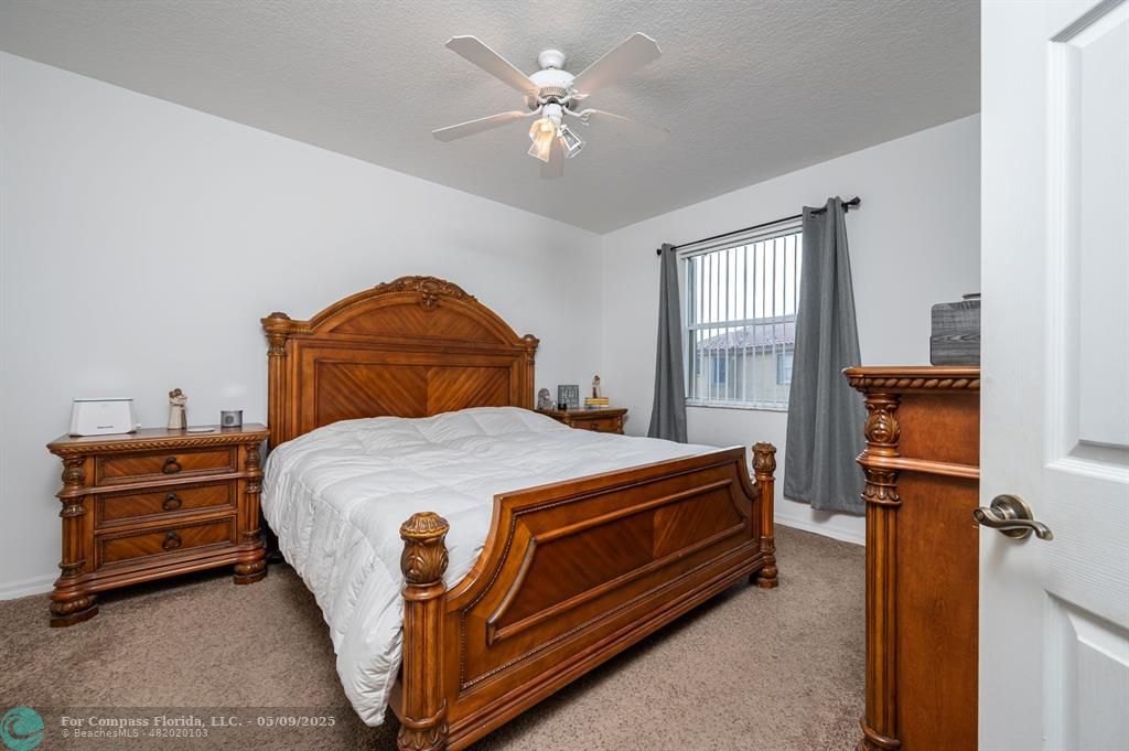 5048 Southwest 136th Avenue Miramar, FL 33027 - Photo 19 of 49 a bedroom with a bed and a chandelier