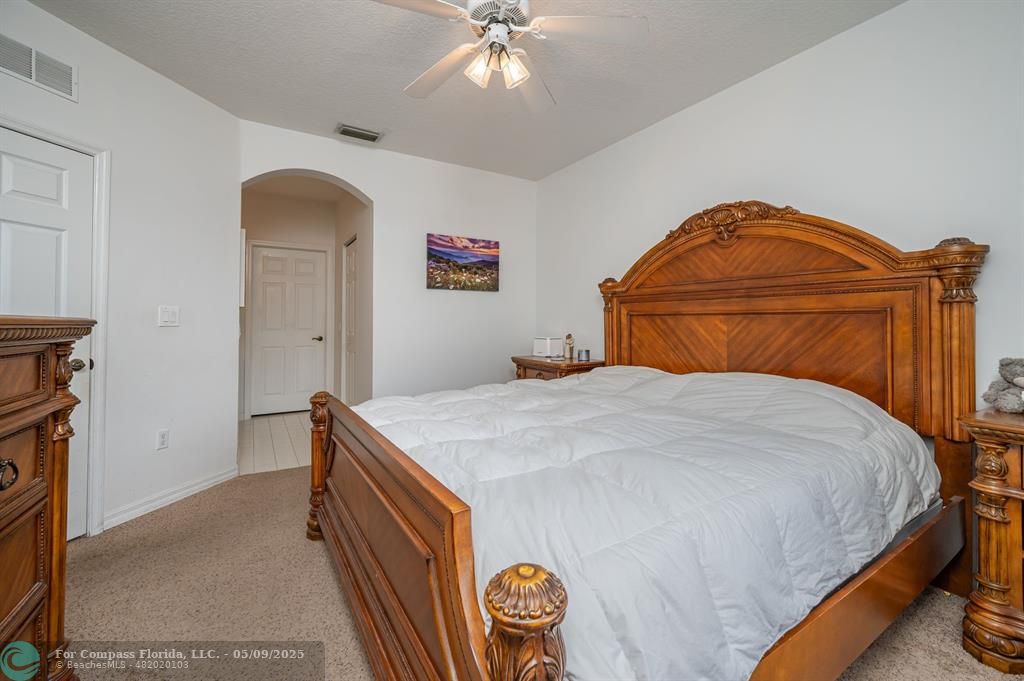 5048 Southwest 136th Avenue Miramar, FL 33027 - Photo 20 of 49 a bedroom with a bed and a chandelier
