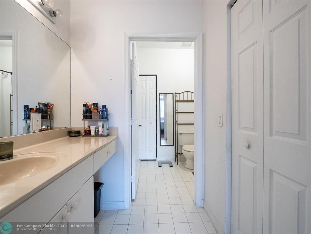 5048 Southwest 136th Avenue Miramar, FL 33027 - Photo 23 of 49 a hallway with a sink and a mirror