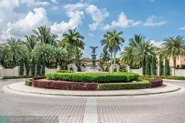 a front view of a house with garden and trees
