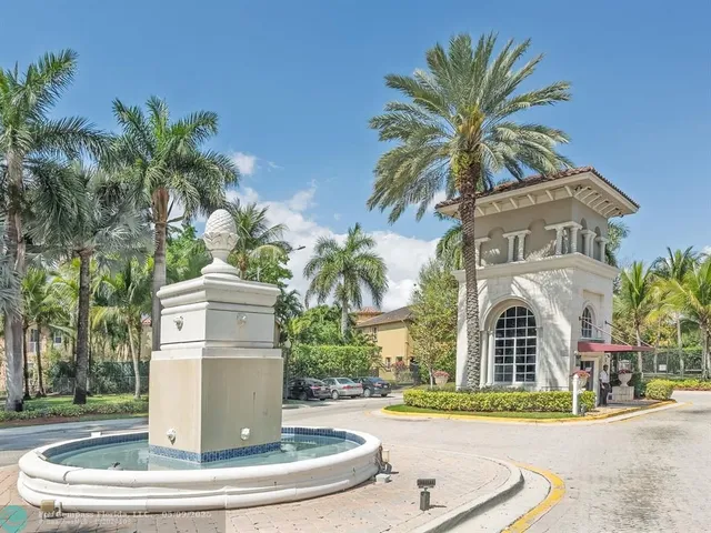 a view of a multi story residential apartment building with a yard