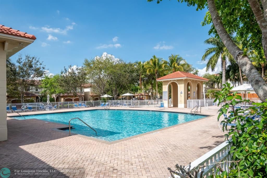 5048 Southwest 136th Avenue Miramar, FL 33027 - Photo 37 of 49 a view of a swimming pool with a patio and a yard