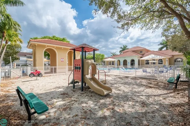 a front view of house with a garden