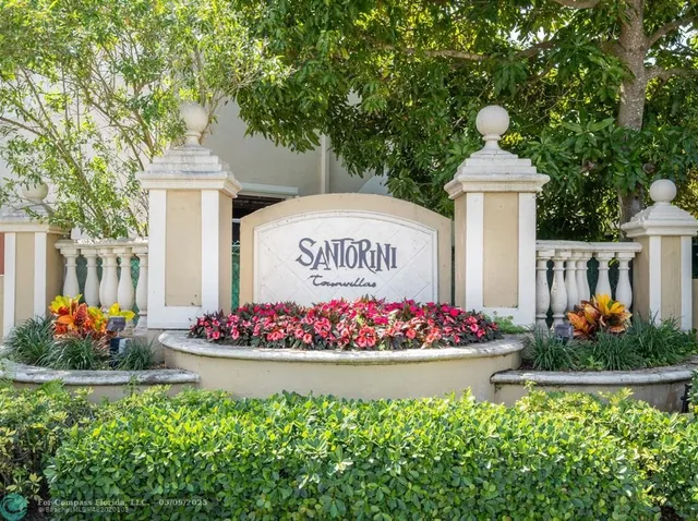 a front view of multi story residential apartment building with an outdoor seating