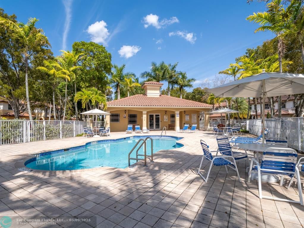5048 Southwest 136th Avenue Miramar, FL 33027 - Photo 41 of 49 a view of a patio with a table and chairs under an umbrella