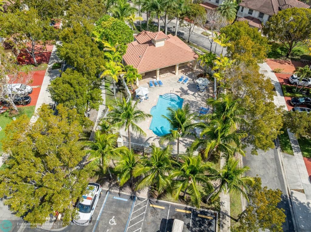 5048 Southwest 136th Avenue Miramar, FL 33027 - Photo 44 of 49 a backyard of a house with table and chairs under an umbrella