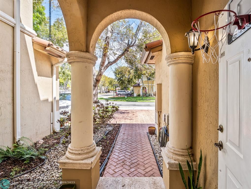 5048 Southwest 136th Avenue Miramar, FL 33027 - Photo 49 of 49 a view of a hallway with wooden floor and glass windows