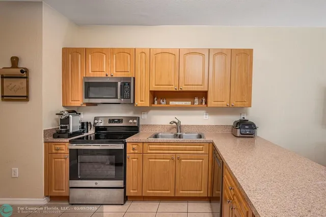 a kitchen with a sink stove and microwave