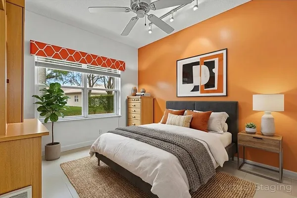 a bedroom with a bed and a potted plant