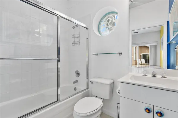 a bathroom with a toilet a sink and a shower