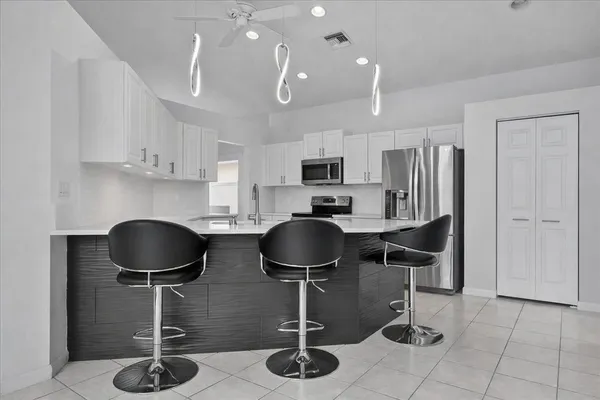 a kitchen with stainless steel appliances granite countertop a stove a refrigerator a stove a microwave a sink and cabinets