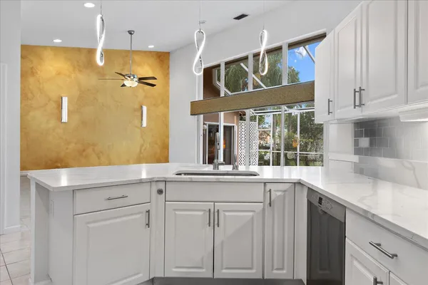 a kitchen with cabinets and window