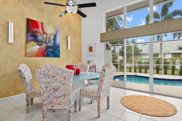 a view of a dining room with furniture and a potted plant