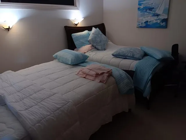 a bed sitting in a bedroom next to a lamp