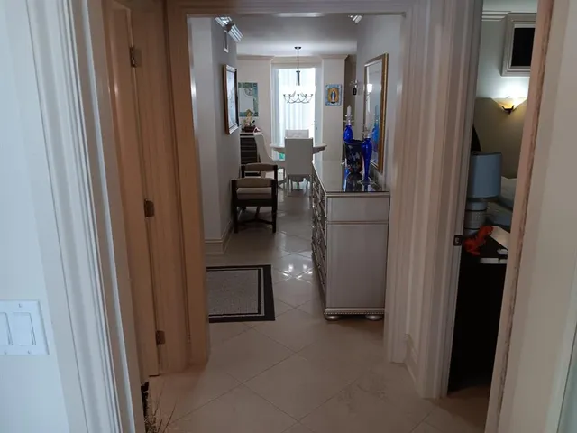 a view of a hallway and a livingroom with furniture