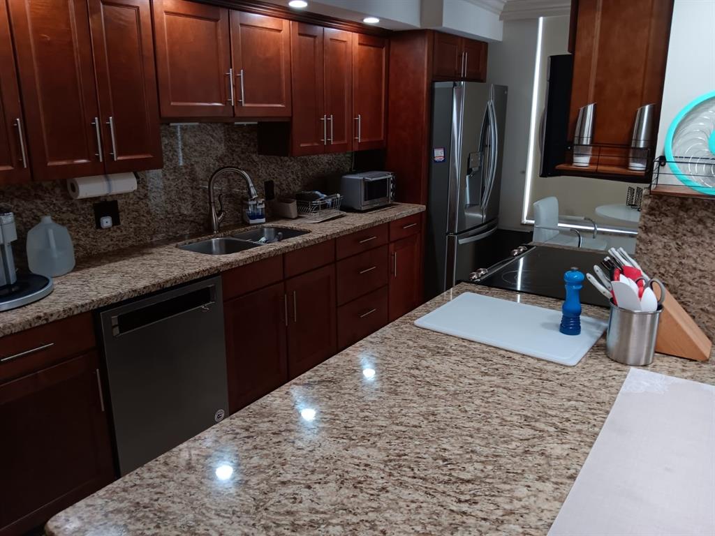 4280 Galt Ocean Drive, Unit 4G Fort Lauderdale, FL 33308 - Photo 4 of 24 a kitchen with granite countertop a sink stove and cabinets